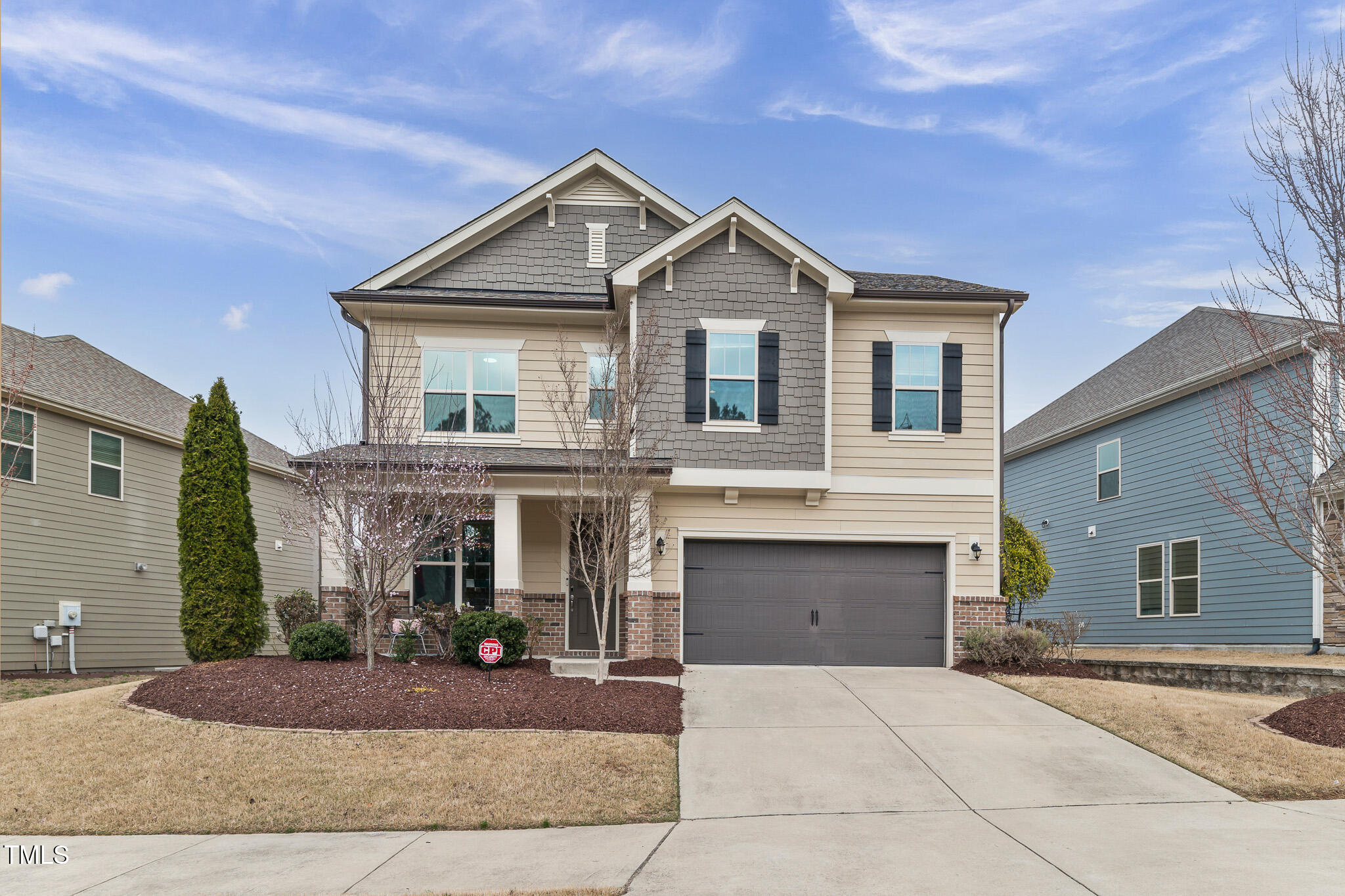 a front view of a house with yard and garage