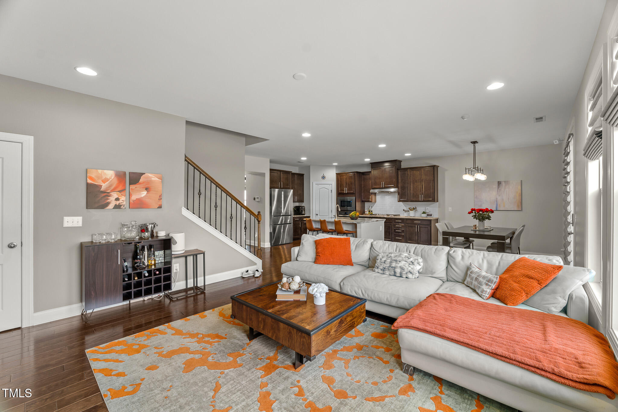 1715 Capstone Drive Durham, NC 27713 - Photo 13 of 53 a living room with furniture kitchen view and a wooden floor
