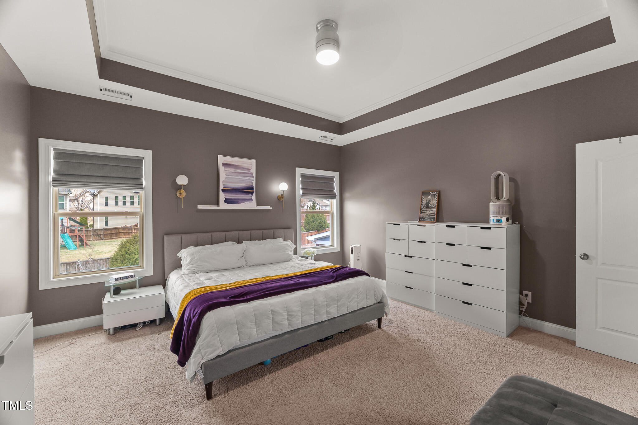 1715 Capstone Drive Durham, NC 27713 - Photo 23 of 53 a bedroom with a bed and dresser with mirror