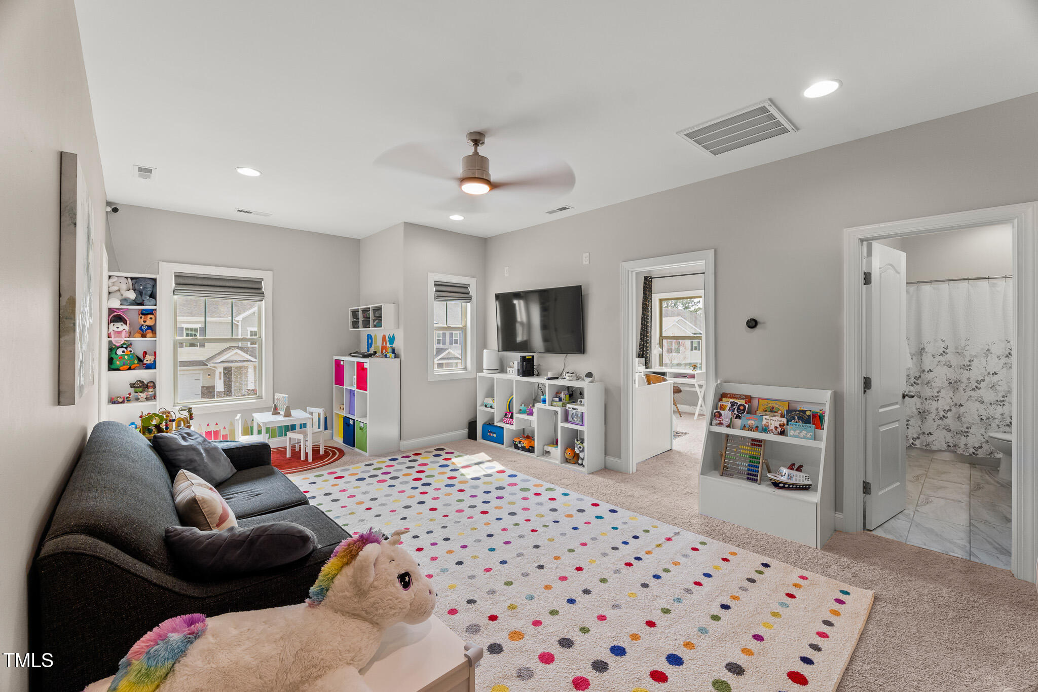 1715 Capstone Drive Durham, NC 27713 - Photo 30 of 53 a bedroom with furniture a flat tv screen and a chandelier