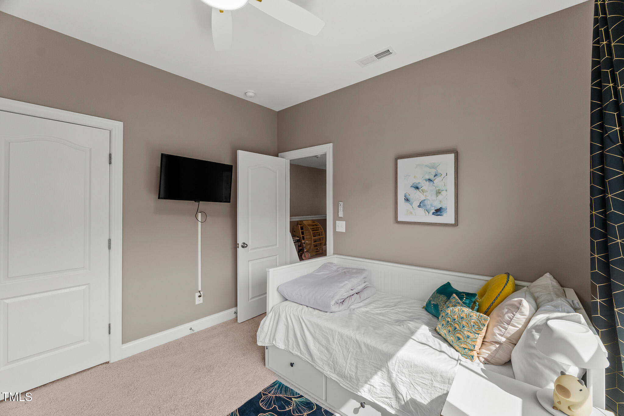 1715 Capstone Drive Durham, NC 27713 - Photo 37 of 53 a bedroom with a bed and a flat screen tv