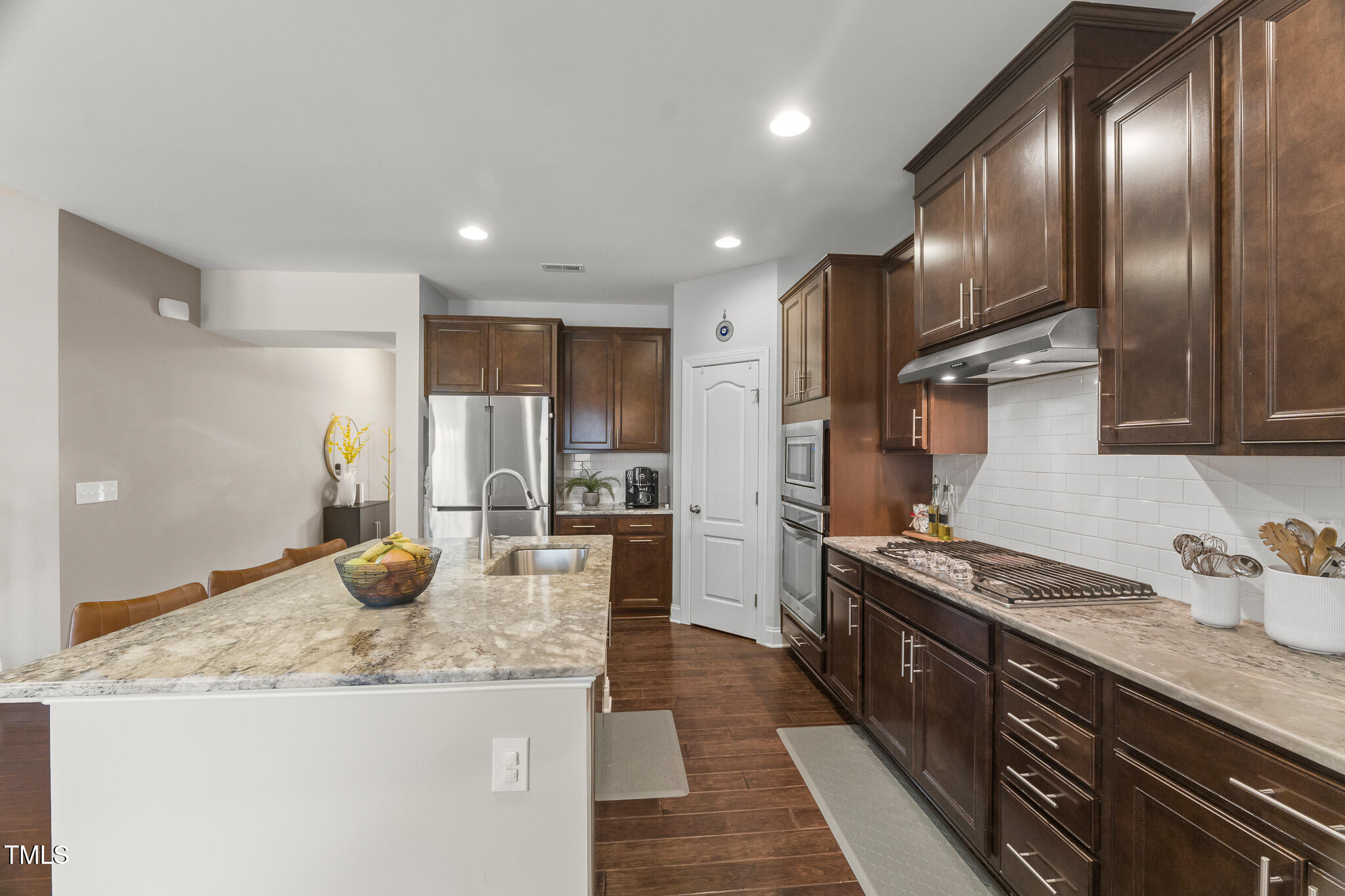1715 Capstone Drive Durham, NC 27713 - Photo 4 of 53 a kitchen with granite countertop stainless steel appliances and wooden cabinets