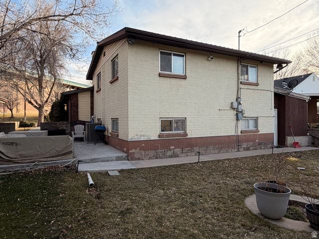 574 West Harding Avenue Cedar City, UT 84720 - Photo 26 of 43 Rear view of property featuring brick siding, a yard, and a patio area