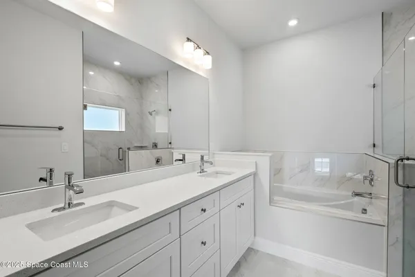 a bathroom with a double vanity sink mirror and double
