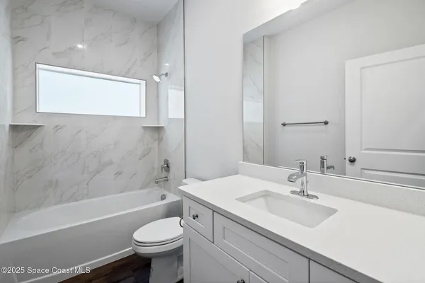 a bathroom with a bathtub and a toilet