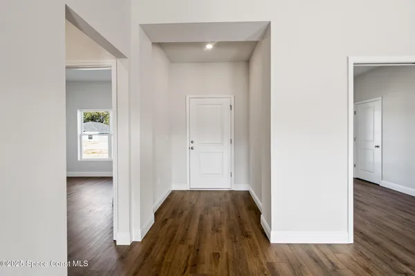 a view of a hallway view with wooden floor and staircase