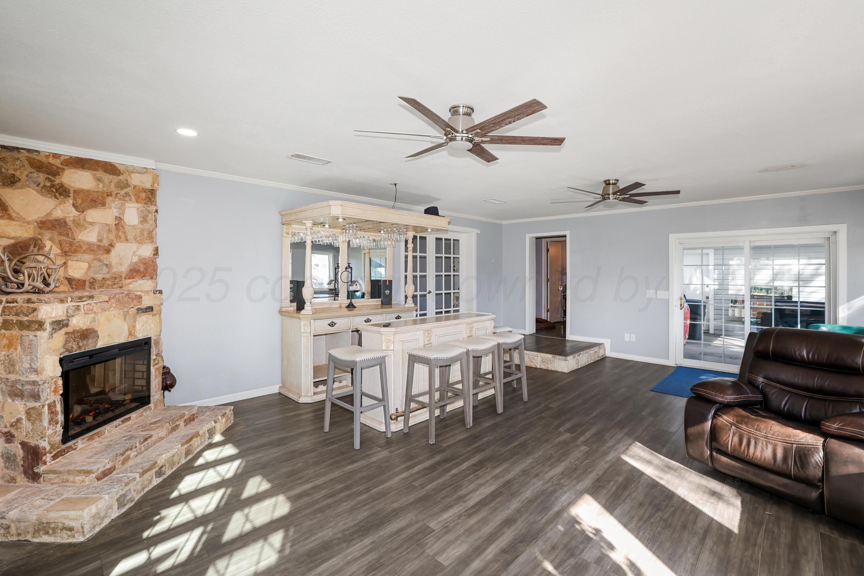 620 North Main Street Stratford, TX 79084 - Photo 18 of 51 a living room with furniture a fireplace and a flat screen tv