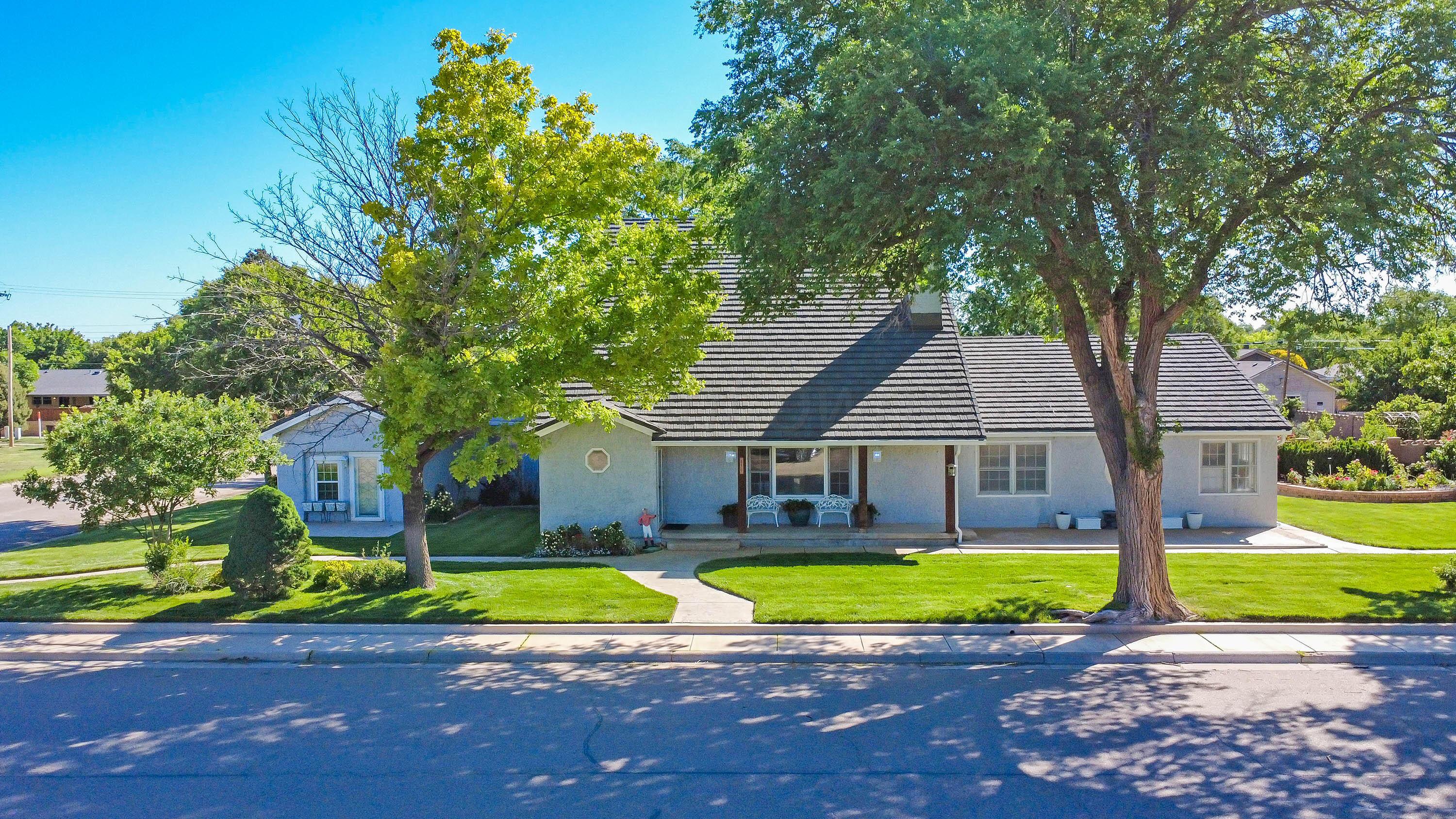 620 North Main Street Stratford, TX 79084 - Photo 3 of 51 a view of a house with a big yard plants and large trees