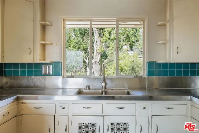 a kitchen with a sink and large window