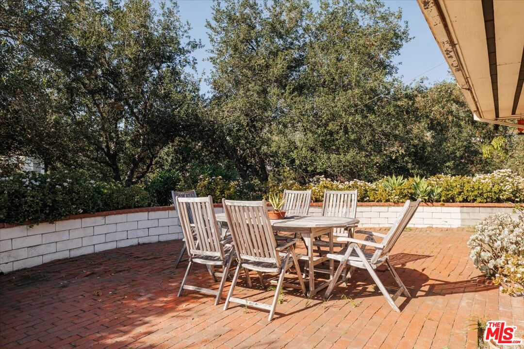 3200 Deronda Drive Los Angeles, CA 90068 - Photo 19 of 28 a view of a patio with table and chairs with wooden floor and fence