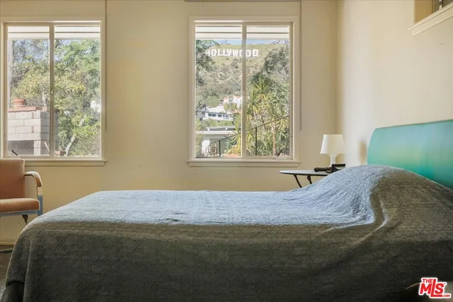 a bedroom with a bed and a window