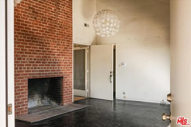 a view of wooden door chandelier and a fireplace