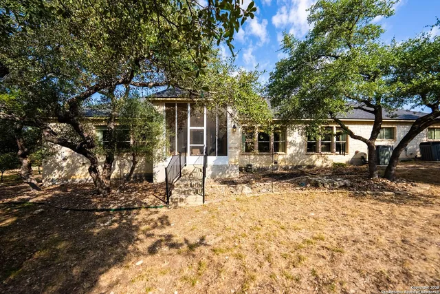 a view of a house with a yard covered in snow