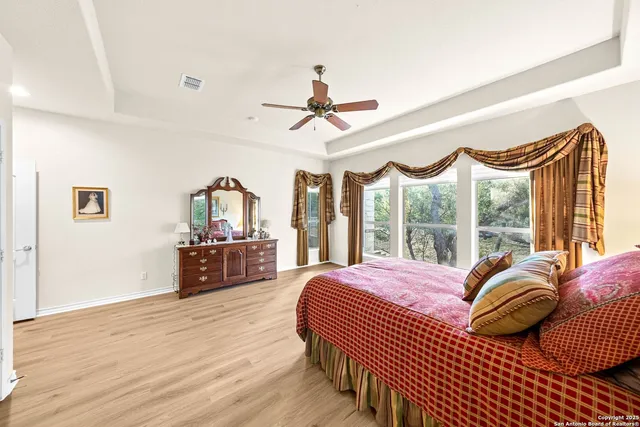 a bathroom with a tub a sink and a mirror