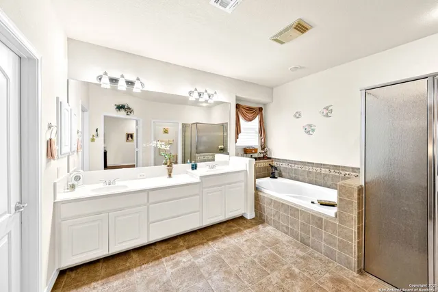a hallway with a sink and cabinets