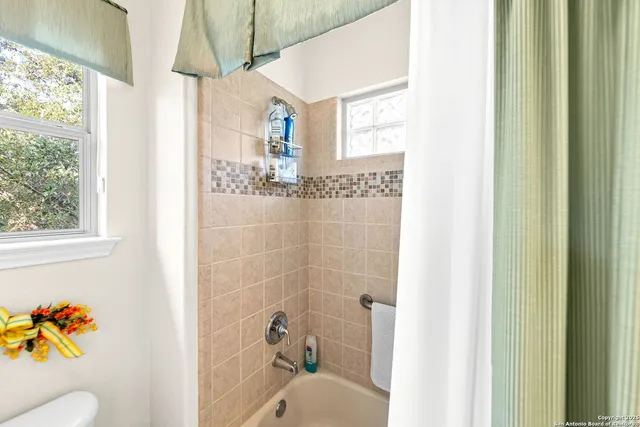 an aerial view of residential houses with city view