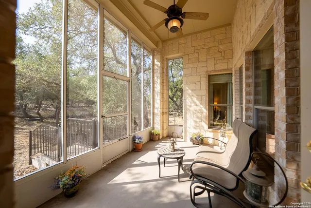 an aerial view of residential houses with outdoor space and trees