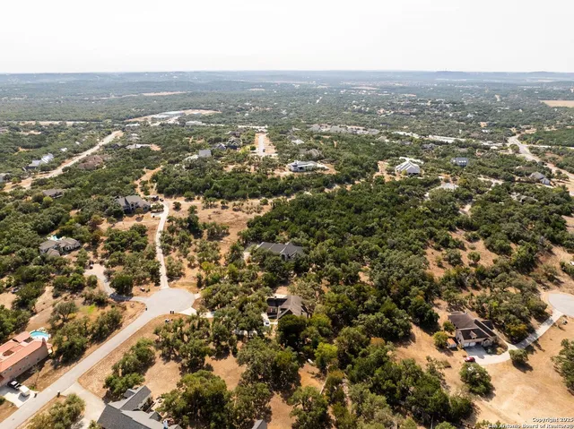 a front view of a house with lots of trees