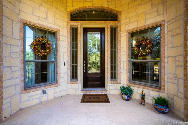 a living room with furniture a flat screen tv and a book shelf