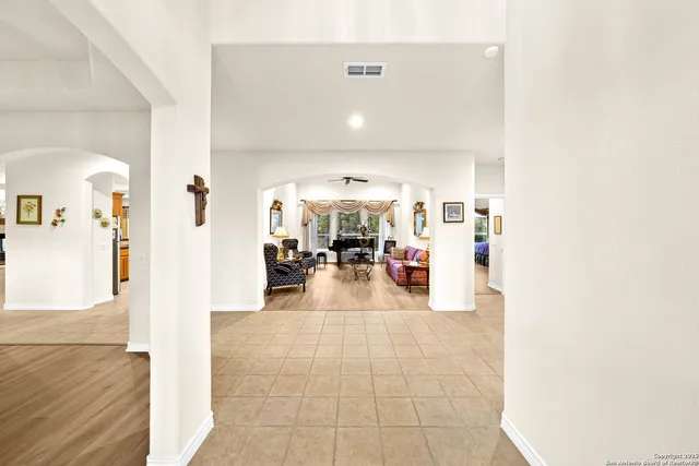 a living room with furniture large window and a fireplace