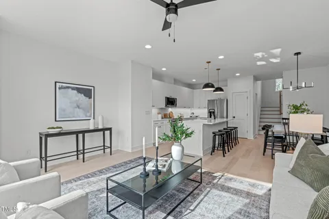 a living room with furniture kitchen view and a table