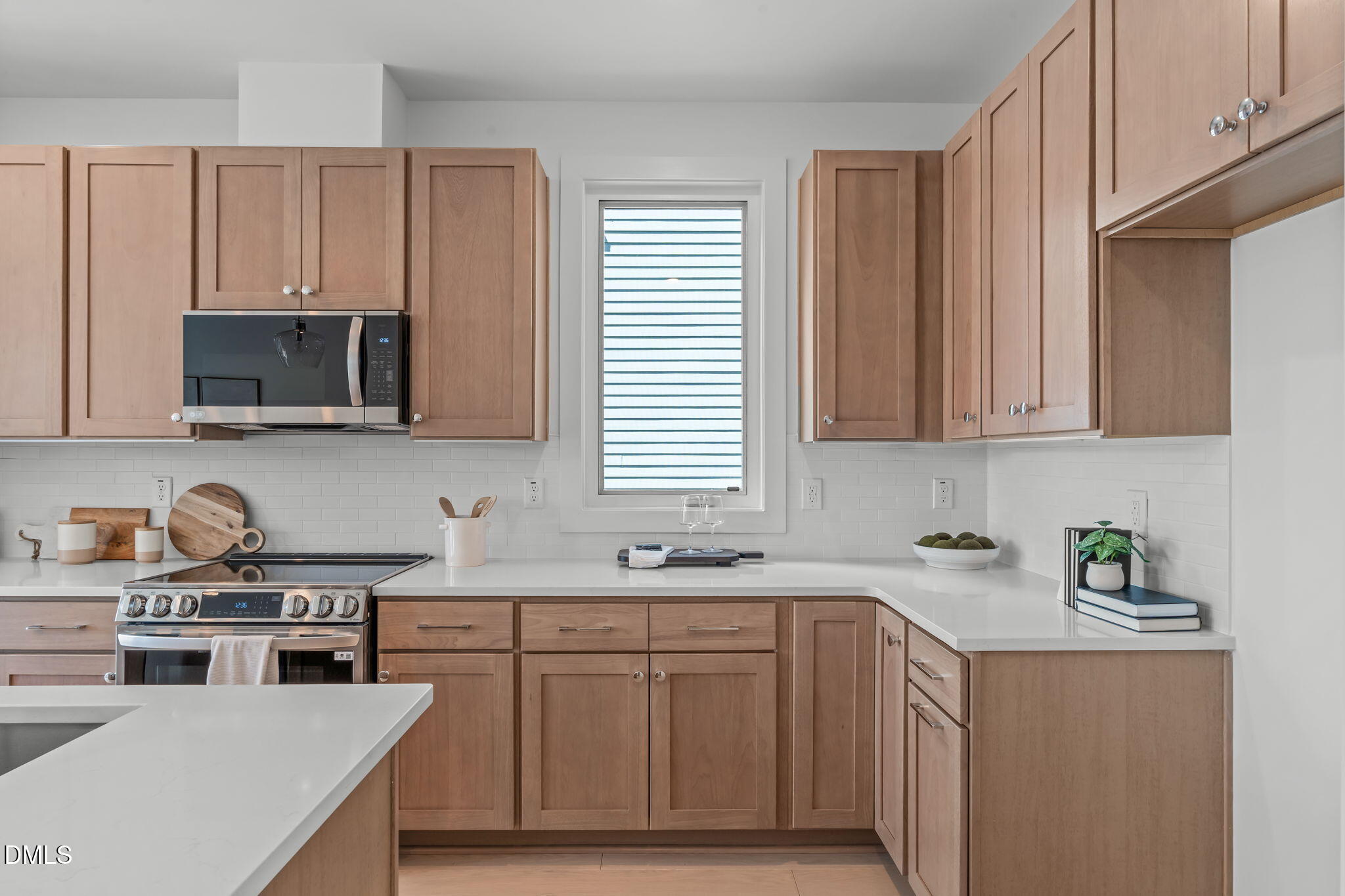 600 Rocky Knob Court Raleigh, NC 27601 - Photo 5 of 49 a kitchen with stainless steel appliances granite countertop a sink a stove a microwave and cabinets