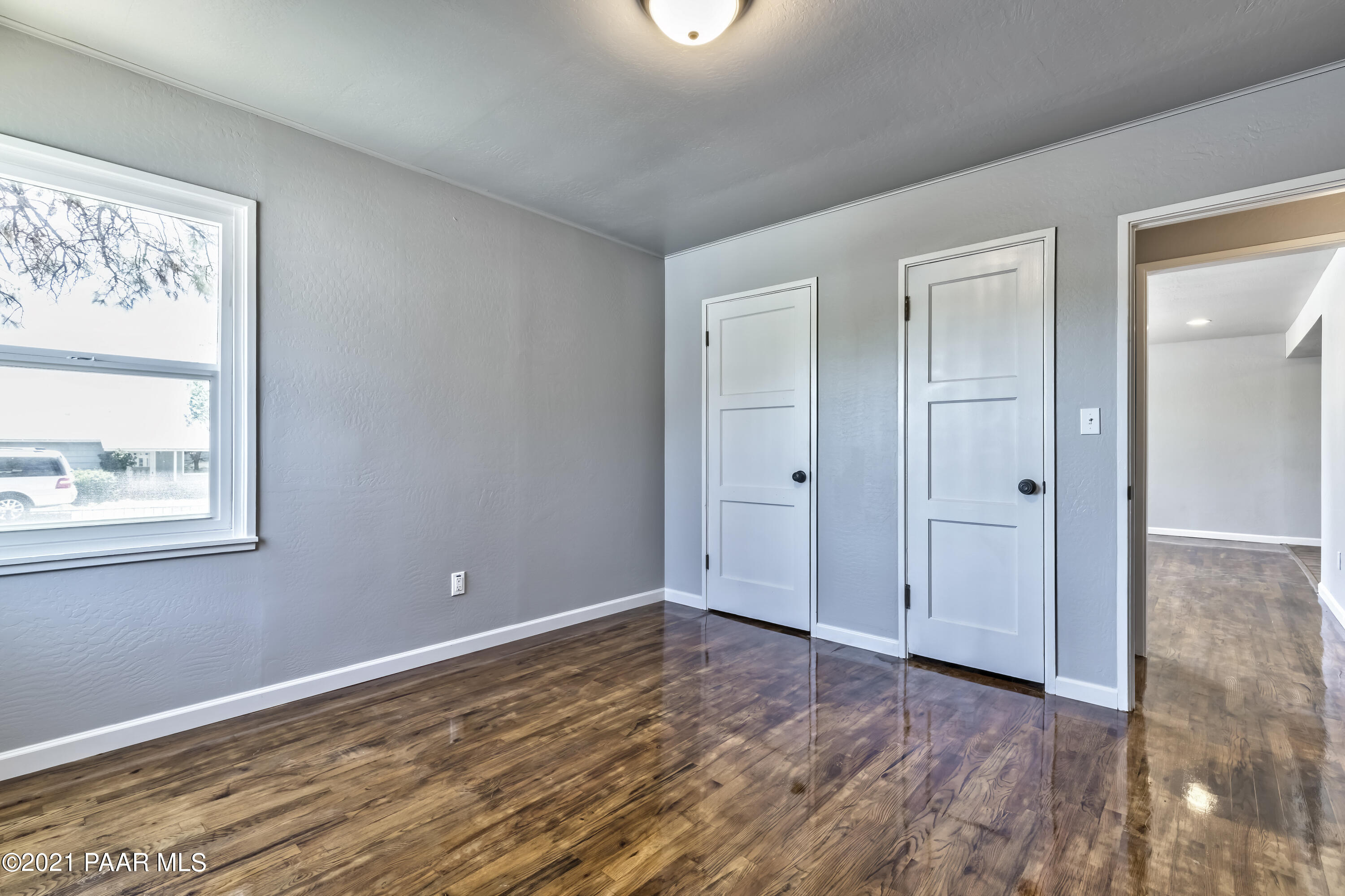 844 Flora Street Prescott, AZ 86301 - Photo 17 of 29 a view of an empty room with wooden floor and a window
