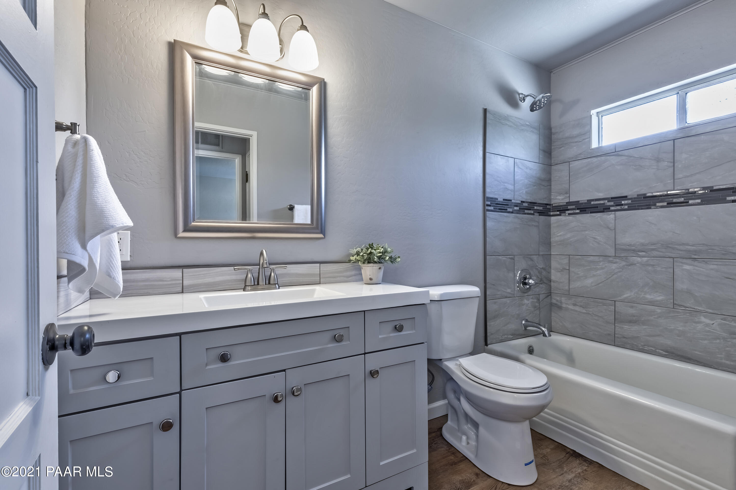 844 Flora Street Prescott, AZ 86301 - Photo 18 of 29 a bathroom with a toilet a sink a tub and mirror