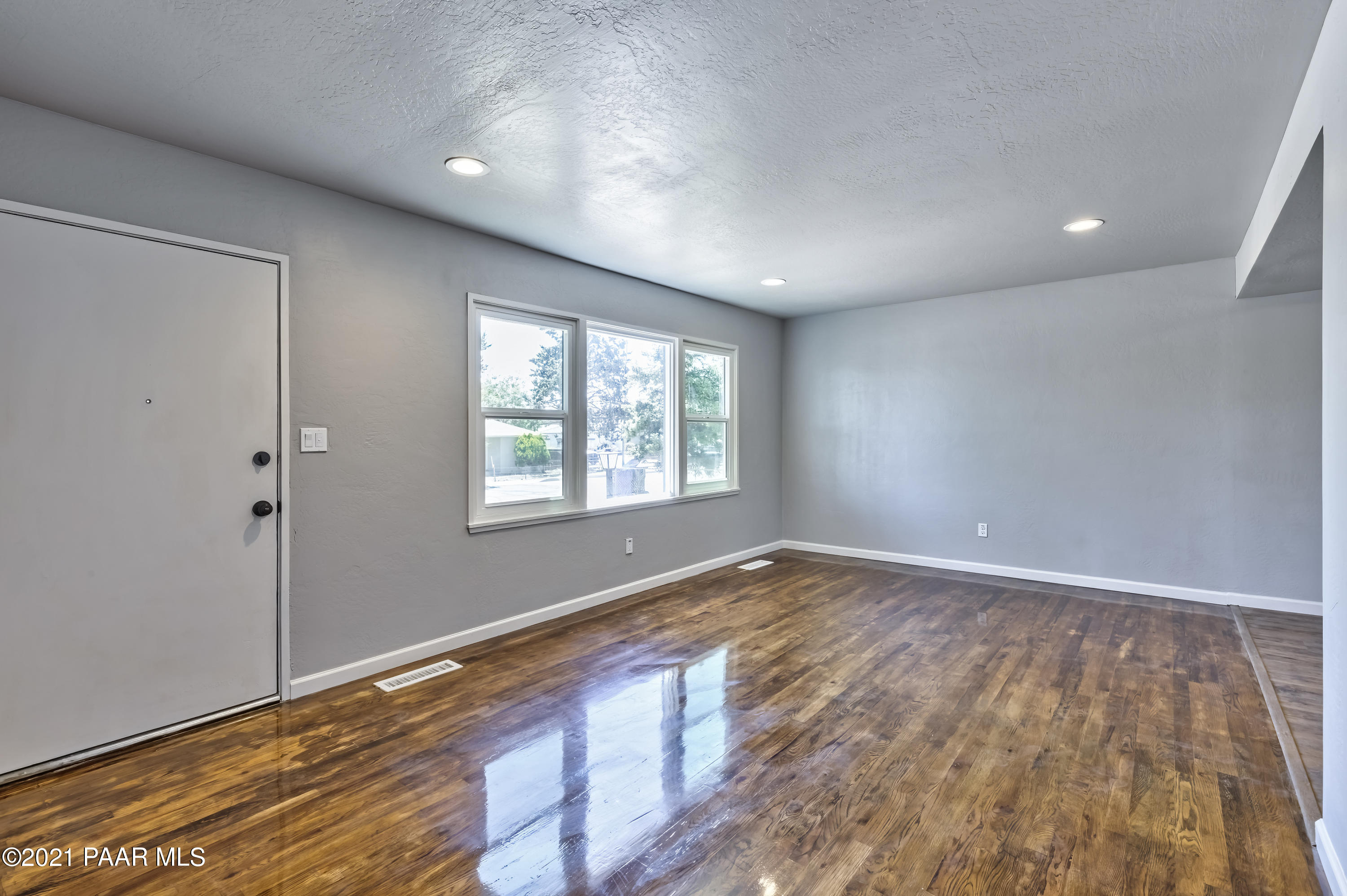 844 Flora Street Prescott, AZ 86301 - Photo 5 of 29 an empty room with wooden floor and windows