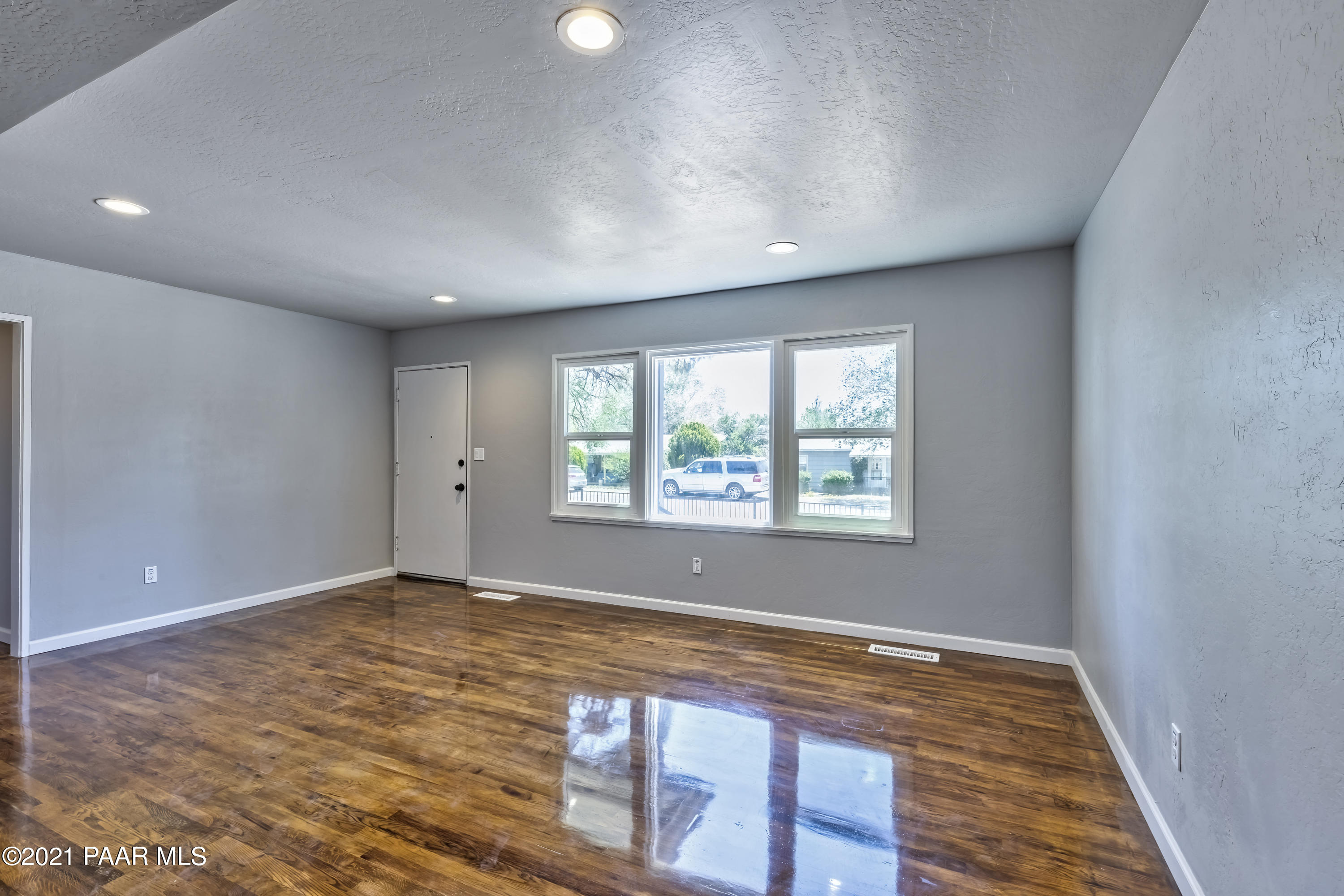 844 Flora Street Prescott, AZ 86301 - Photo 7 of 29 an empty room with wooden floor and windows