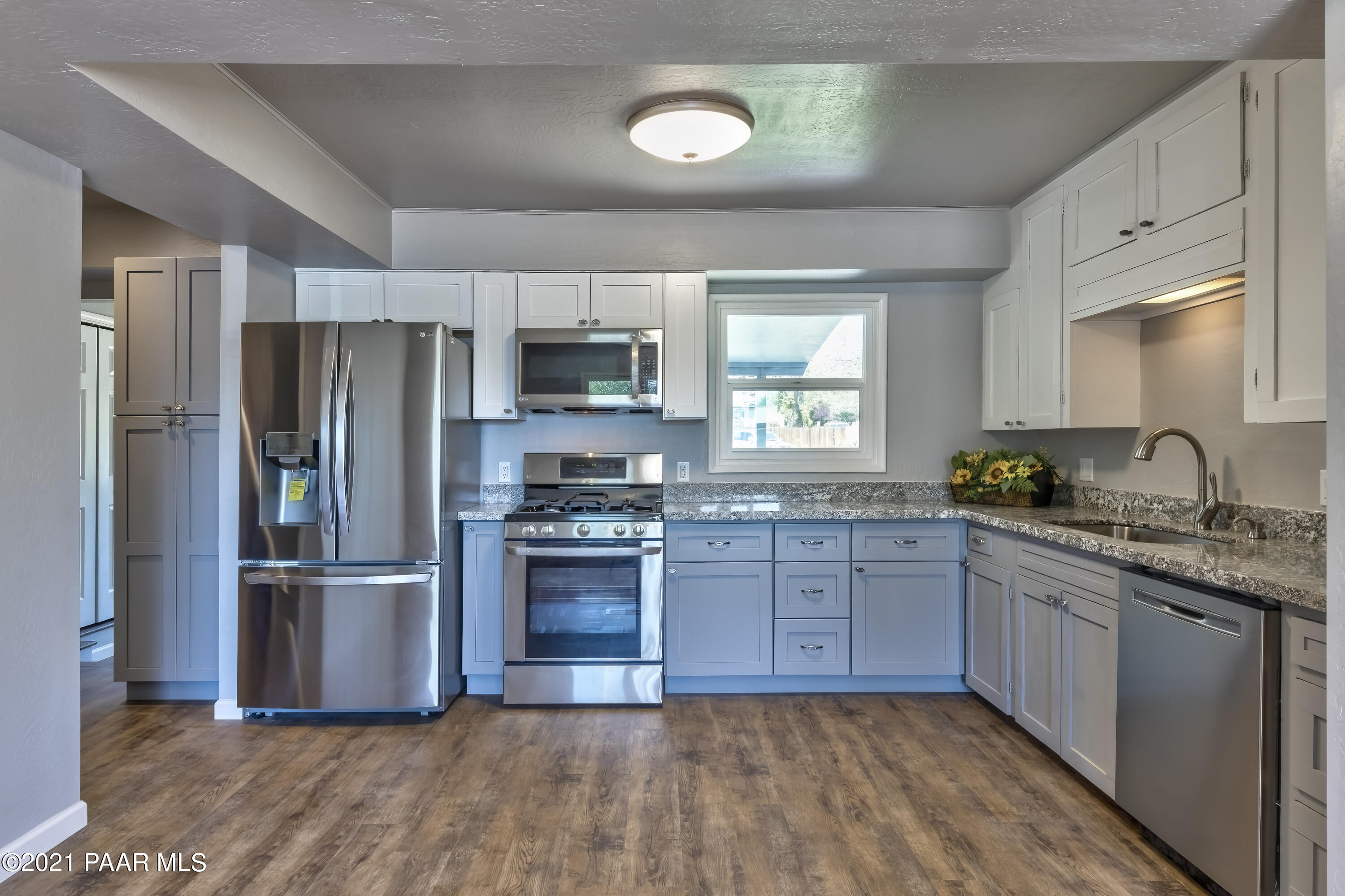 844 Flora Street Prescott, AZ 86301 - Photo 9 of 29 a kitchen with stainless steel appliances granite countertop a refrigerator and a stove top oven