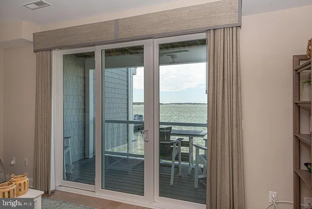 a view of a kitchen with kitchen island and stainless steel appliances