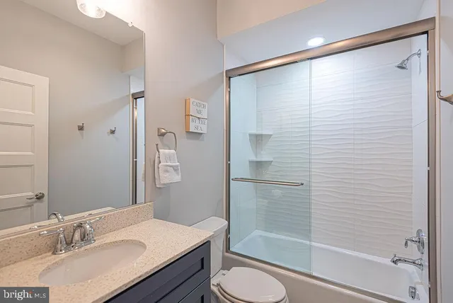 a kitchen with stainless steel appliances granite countertop a refrigerator a stove and a sink