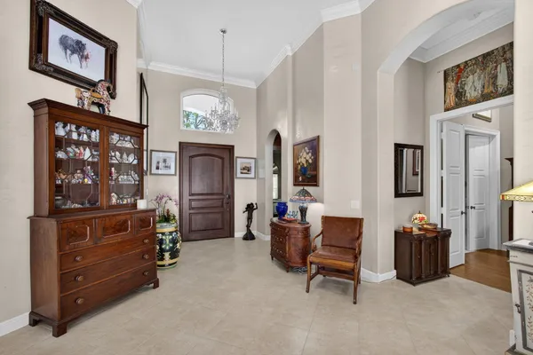 a dining room with wooden floor and large windows