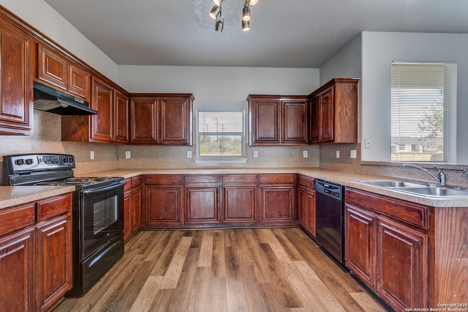 21715 Hanover Crest San Antonio, TX 78259 - Photo 12 of 25 a kitchen with stainless steel appliances granite countertop wooden cabinets a stove top oven a sink and dishwasher a oven with wooden floor