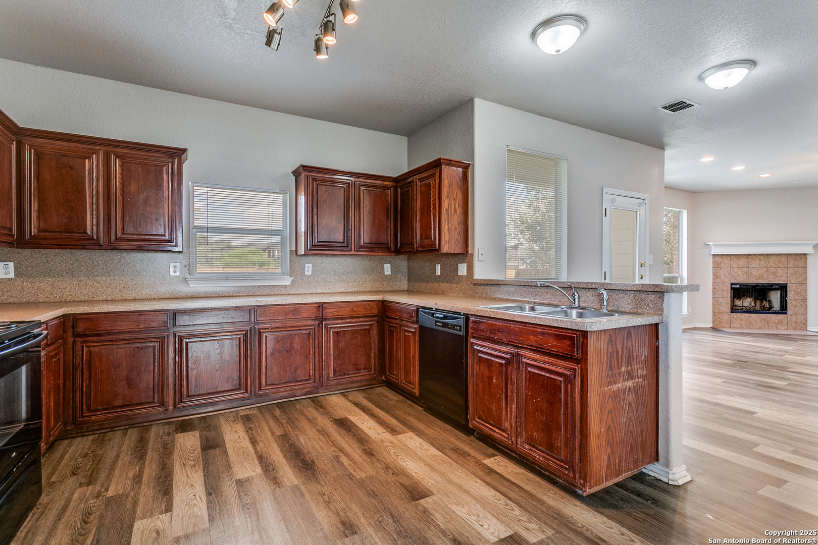 21715 Hanover Crest San Antonio, TX 78259 - Photo 14 of 25 a large kitchen with stainless steel appliances granite countertop wooden cabinets a sink and dishwasher