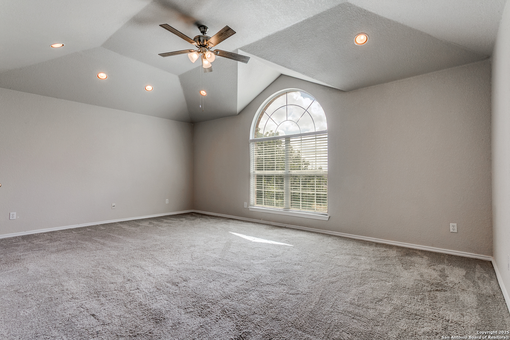 21715 Hanover Crest San Antonio, TX 78259 - Photo 15 of 25 an empty room with windows and ceiling fan