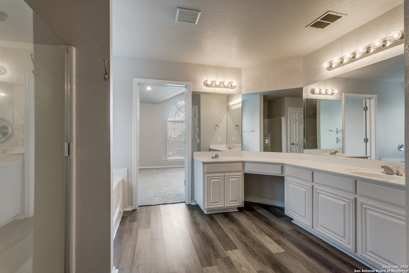 21715 Hanover Crest San Antonio, TX 78259 - Photo 16 of 25 a large bathroom with a double vanity sink and mirror