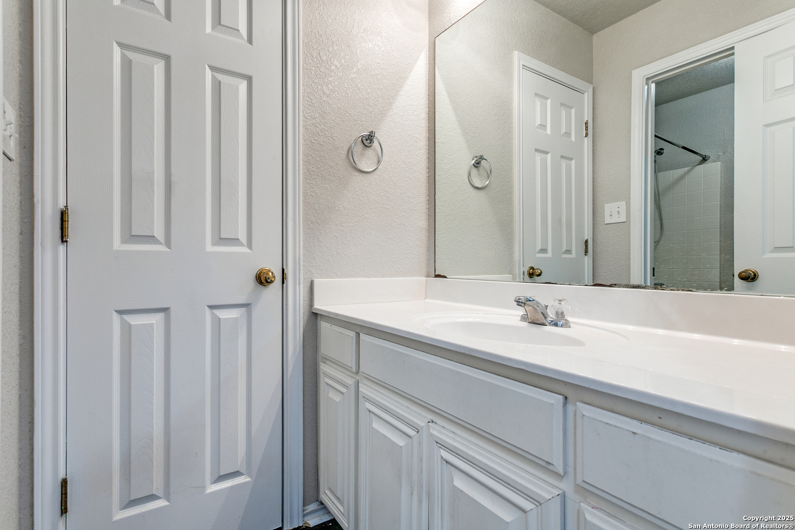 21715 Hanover Crest San Antonio, TX 78259 - Photo 21 of 25 a bathroom with a granite countertop sink and a mirror