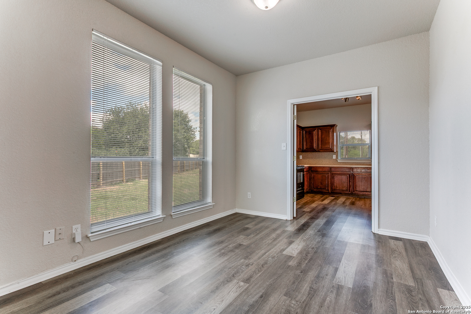 21715 Hanover Crest San Antonio, TX 78259 - Photo 7 of 25 an empty room with wooden floor and a window