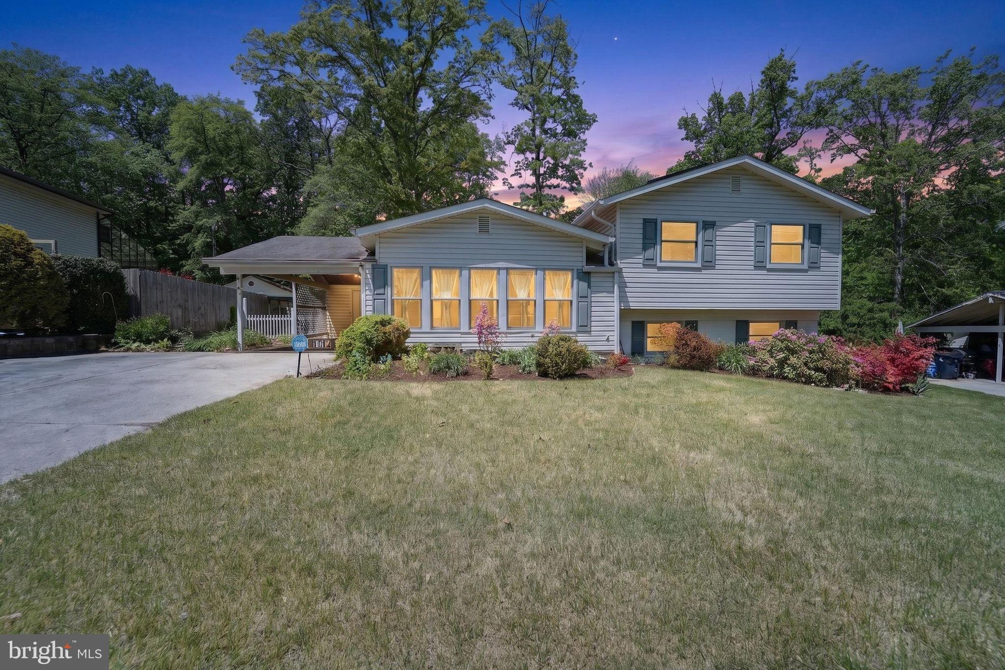 a front view of a house with a garden and yard