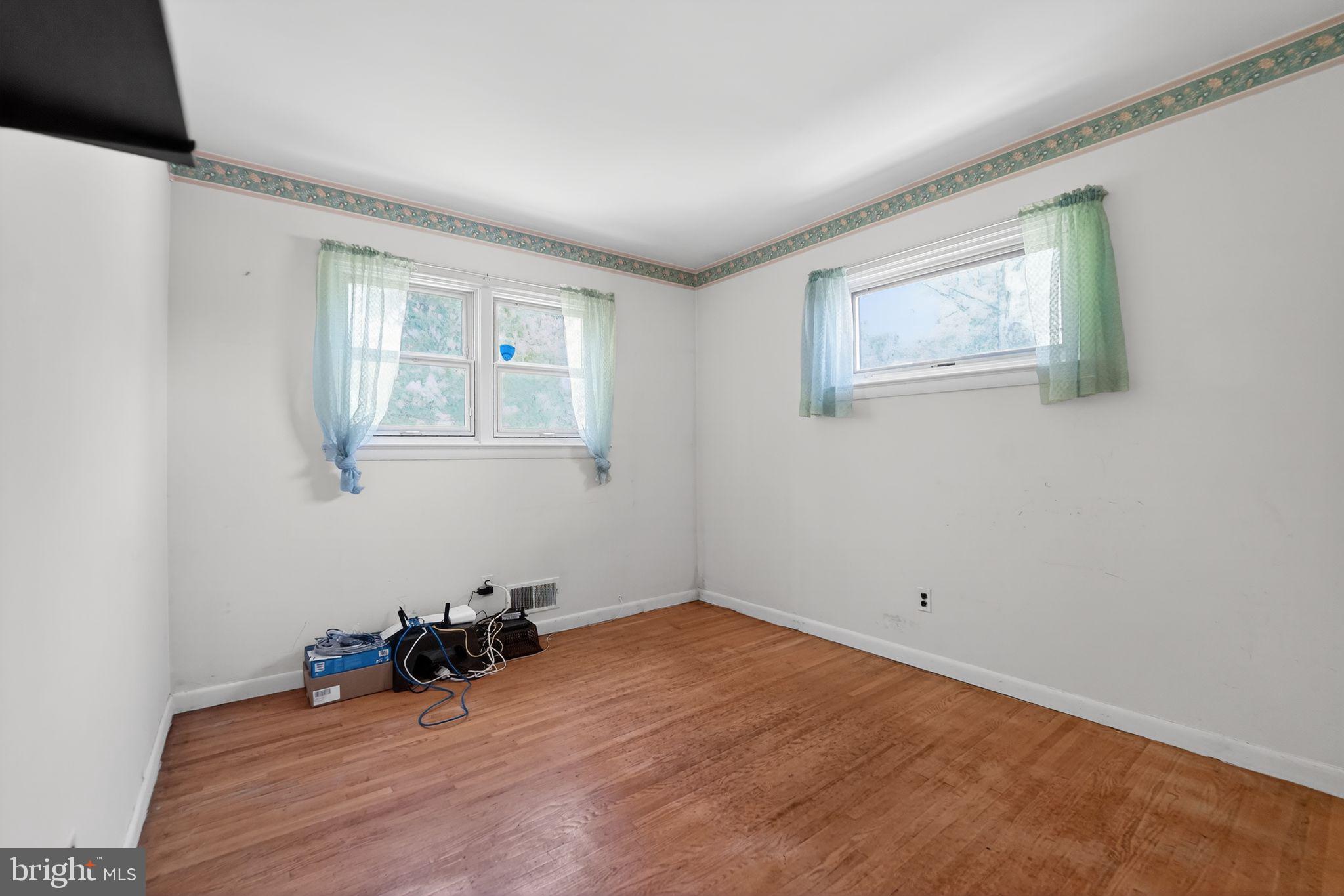 7012 Redmiles Road Laurel, MD 20707 - Photo 16 of 31 a view of a room with wooden floor and windows