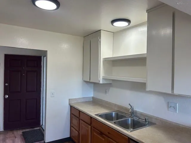 a kitchen with a sink and cabinets