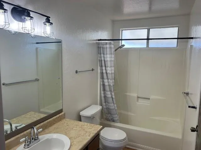 a bathroom with a toilet a sink and shower