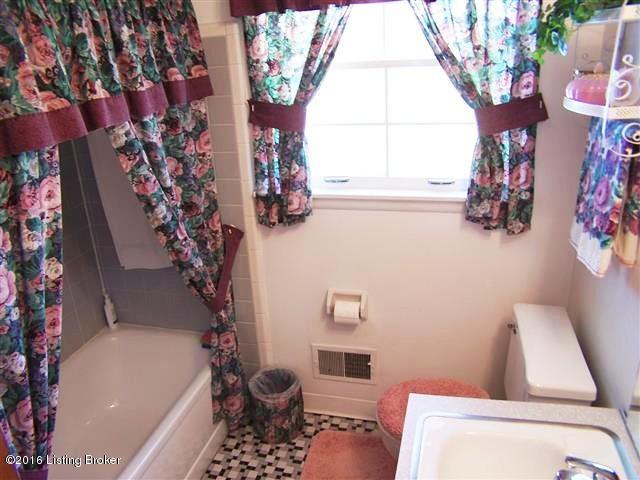 10907 Deering Road Louisville, KY 40272 - Photo 37 of 38 Full Bath with tiled shower walls and a bath tub, tile flooring, linen closet, window and full size mirror.