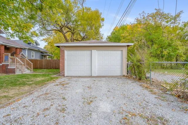 a front view of house with backyard and trees
