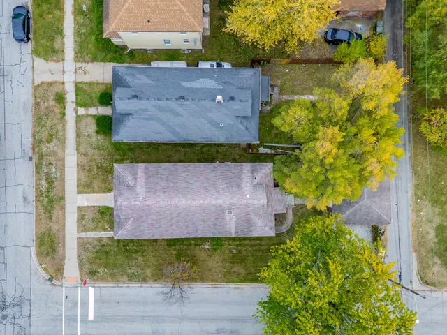 an aerial view of a house with a yard