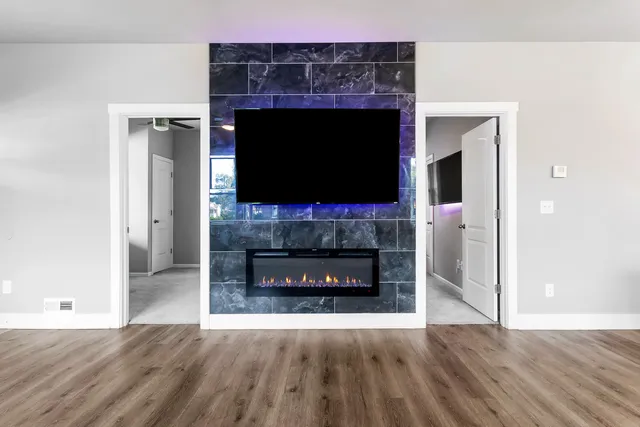 a living room with a fireplace and a flat screen tv