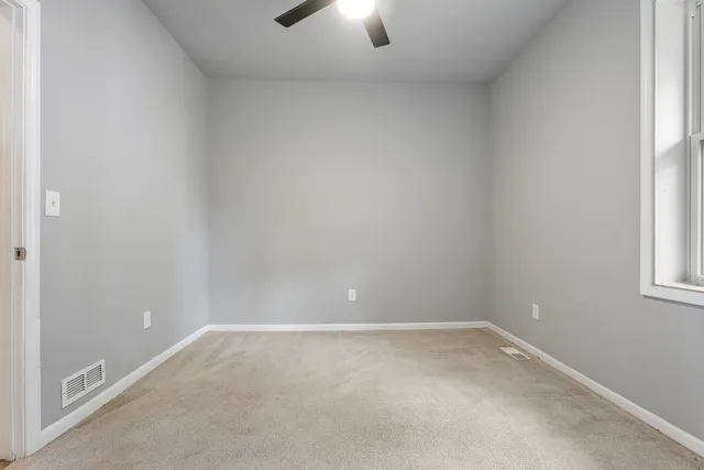 a view of an empty room and window