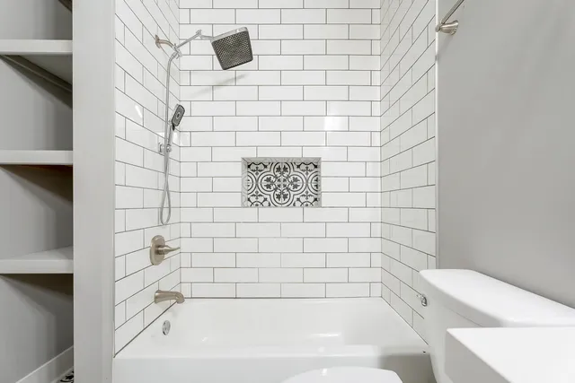 a bathroom with a bathtub and shower